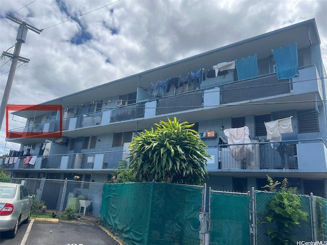 1103 Kokea St Unit K303, Honolulu, HI 96817 - view of building exterior with fence and uncovered parking