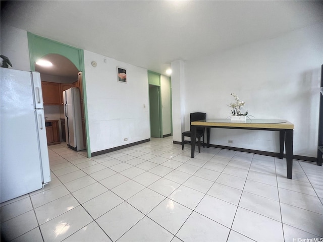 1103 Kokea St Unit K303, Honolulu, HI 96817 - interior space featuring baseboards, light tile patterned flooring, and freestanding refrigerator