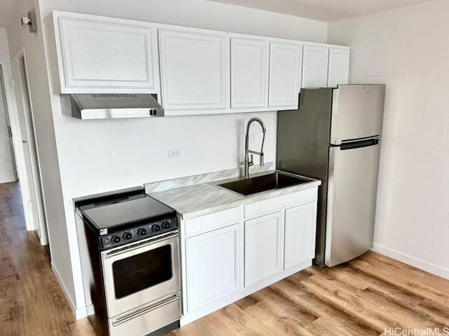 2122 Lime St Unit 604, Honolulu, HI 96826 - kitchen with appliances with stainless steel finishes, under cabinet range hood, light wood-style floors, and white cabinetry