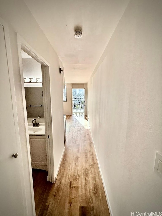 2122 Lime St Unit 604, Honolulu, HI 96826 - corridor with wood finished floors, baseboards, and a sink