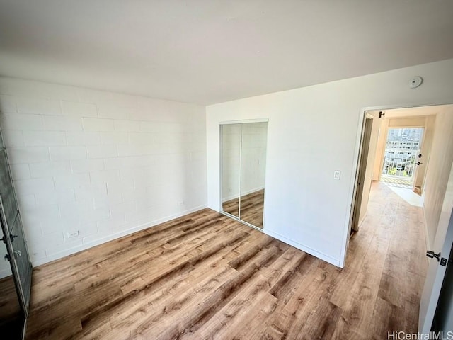 2122 Lime St Unit 604, Honolulu, HI 96826 - unfurnished bedroom with wood finished floors, a closet, and baseboards