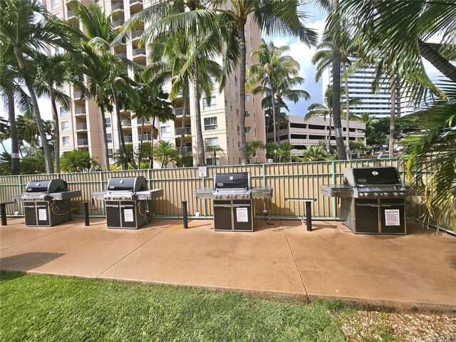 view of patio with a grill and fence