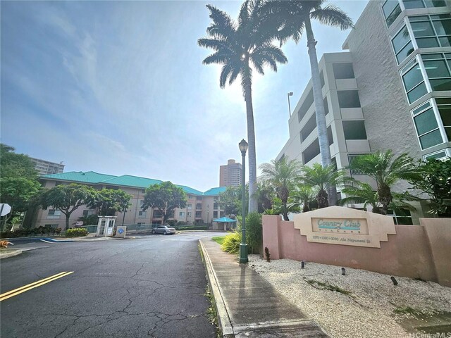 view of road featuring curbs, sidewalks, and street lighting