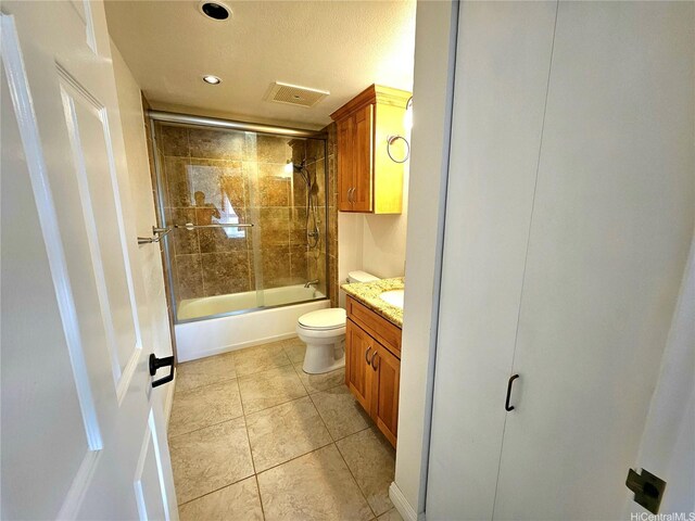 full bathroom with recessed lighting, vanity, tile patterned floors, toilet, and combined bath / shower with glass door