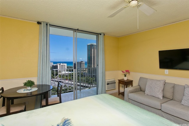 1920 Ala Moana Blvd Unit 2013, Honolulu, HI 96815 - bedroom featuring a wall of windows, ceiling fan, a wall unit AC, a textured ceiling, and access to outside