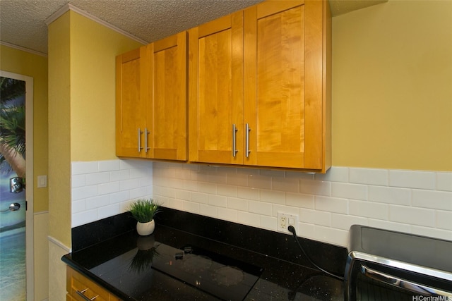 1920 Ala Moana Blvd Unit 2013, Honolulu, HI 96815 - kitchen featuring crown molding, backsplash, a textured ceiling, and brown cabinets