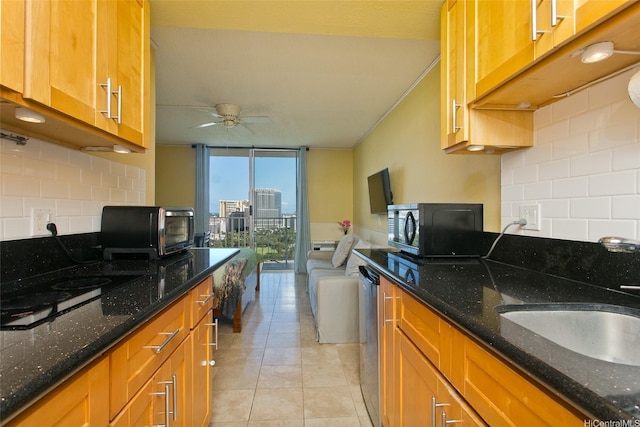 1920 Ala Moana Blvd Unit 2013, Honolulu, HI 96815 - kitchen with decorative backsplash, ceiling fan, black microwave, and a wall of windows
