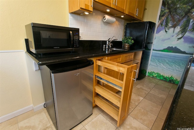 1920 Ala Moana Blvd Unit 2013, Honolulu, HI 96815 - kitchen featuring brown cabinets, a sink, baseboards, backsplash, and black appliances