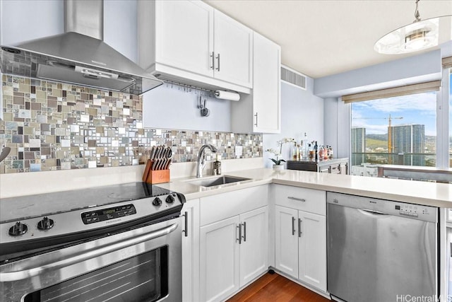 1296 Kapiolani Blvd Unit 3403, Honolulu, HI 96814 - kitchen featuring appliances with stainless steel finishes, a sink, wall chimney range hood, and light countertops