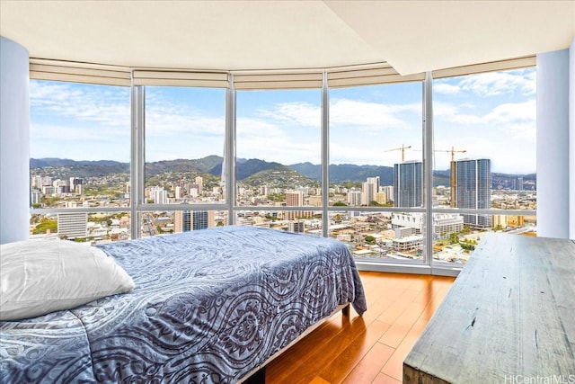 1296 Kapiolani Blvd Unit 3403, Honolulu, HI 96814 - bedroom featuring a view of city, a wall of windows, wood-type flooring, and a mountain view