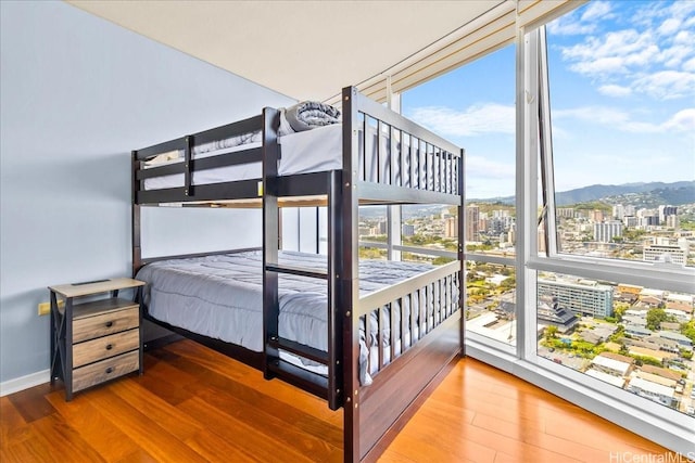 1296 Kapiolani Blvd Unit 3403, Honolulu, HI 96814 - bedroom with wood finished floors, multiple windows, and a city view