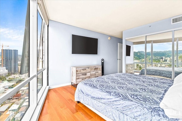1296 Kapiolani Blvd Unit 3403, Honolulu, HI 96814 - bedroom with access to outside, wood finished floors, a view of city, and baseboards