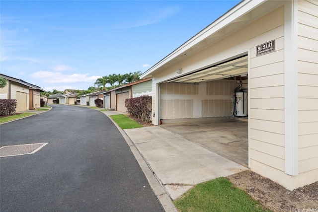 91-2141 Kaiwawalo St, Ewa Beach, HI 96706 - garage featuring water heater and a residential view