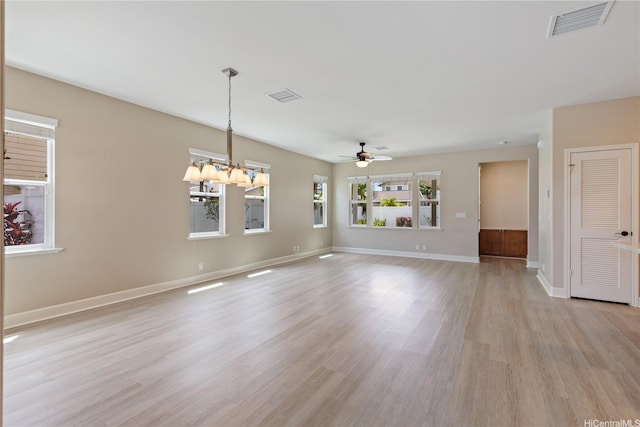 interior space with visible vents, ceiling fan, light wood finished floors, and baseboards