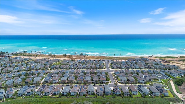 birds eye view of property featuring a view of the beach, a water view, and a residential view