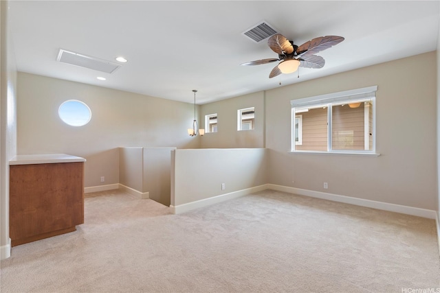 unfurnished room with visible vents, baseboards, and a healthy amount of sunlight