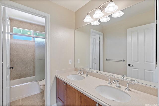 full bath with tile patterned floors, toilet, double vanity, and a sink