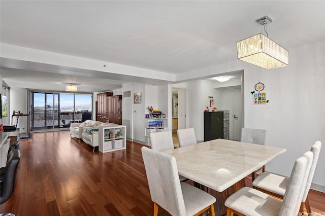 dining area featuring dark wood-style floors and a notable chandelier