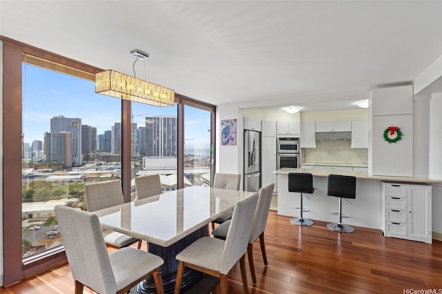 dining room with expansive windows and wood finished floors