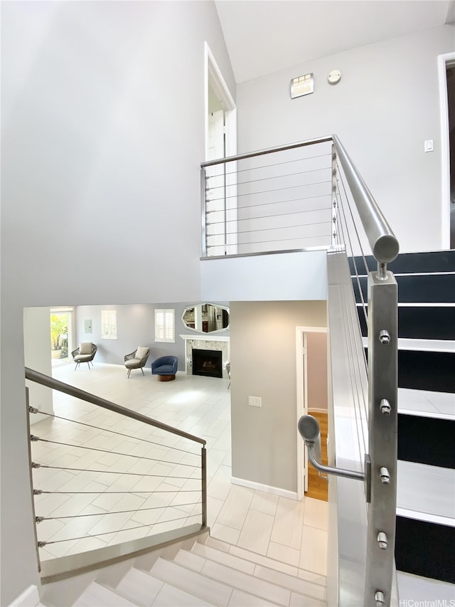 98-1810 Kaahumanu St Unit 3, Pearl City, HI 96782 - stairway with tile patterned flooring, a high ceiling, and a fireplace