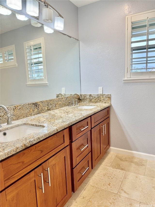 98-1810 Kaahumanu St Unit 3, Pearl City, HI 96782 - full bathroom featuring double vanity, stone tile floors, baseboards, and a sink