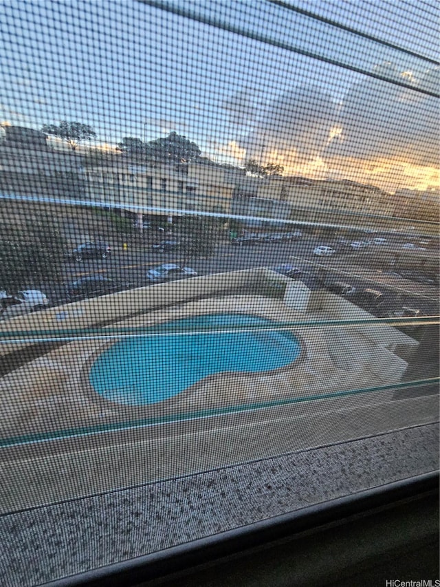 view of swimming pool with fence and a tennis court