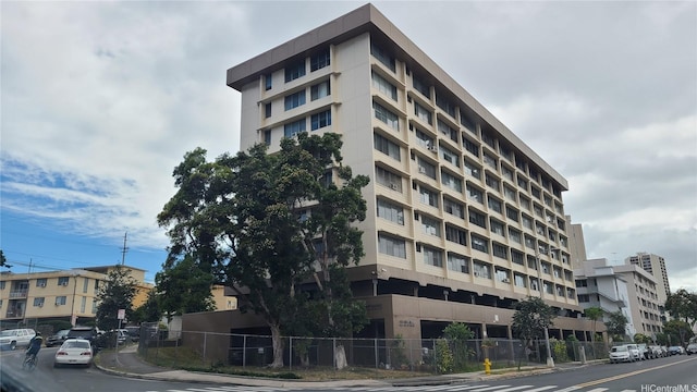 view of building exterior with fence