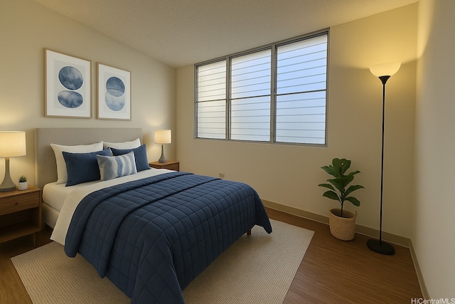 bedroom with wood finished floors and baseboards