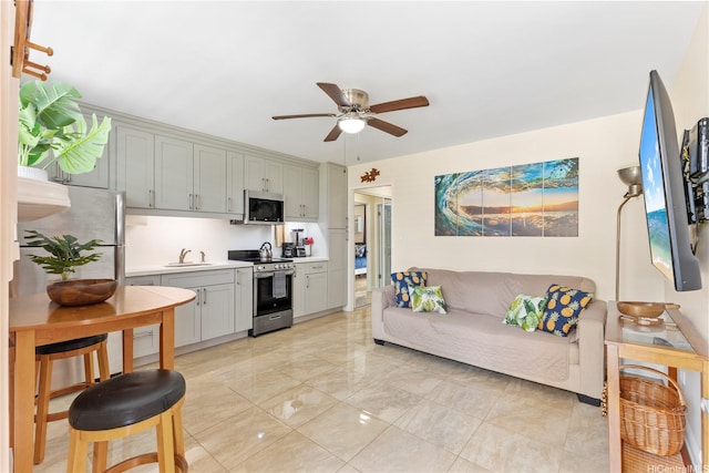 236 Liliuokalani Ave Unit 201, Honolulu, HI 96815 - kitchen with stainless steel appliances, ceiling fan, light countertops, gray cabinetry, and light marble finish flooring