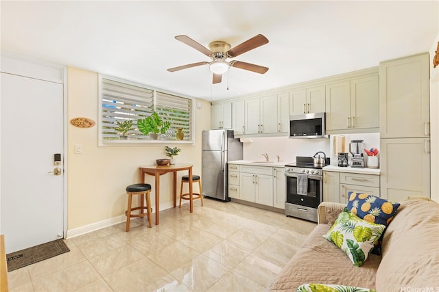 236 Liliuokalani Ave Unit 201, Honolulu, HI 96815 - kitchen with appliances with stainless steel finishes, a ceiling fan, and light countertops