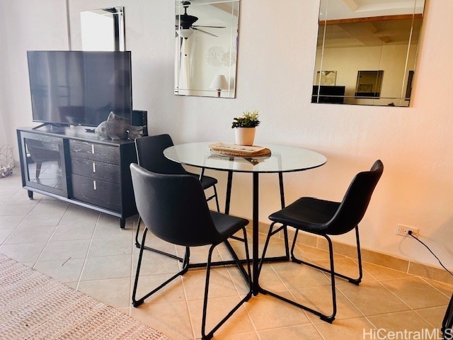tiled dining space featuring a ceiling fan