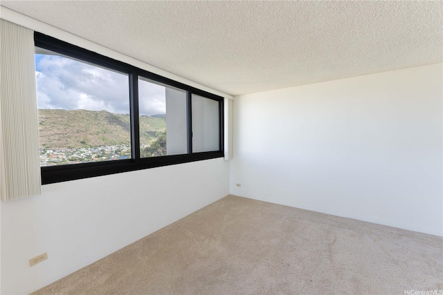 250 Kawaihae St Unit 15B, Honolulu, HI 96825 - carpeted empty room featuring a textured ceiling