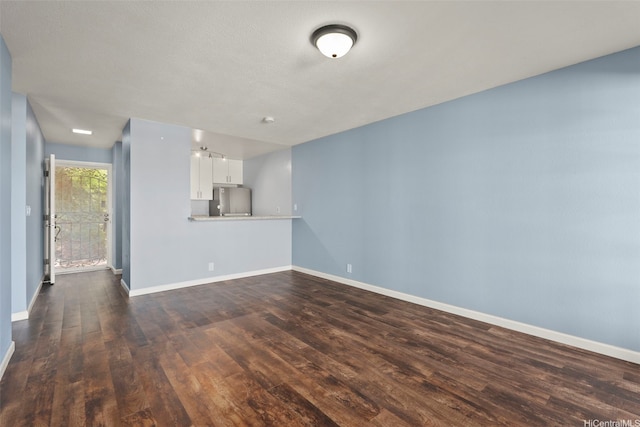92-905 Hame Pl Unit 19-101, Kapolei, HI 96707 - unfurnished living room featuring dark wood-type flooring and baseboards