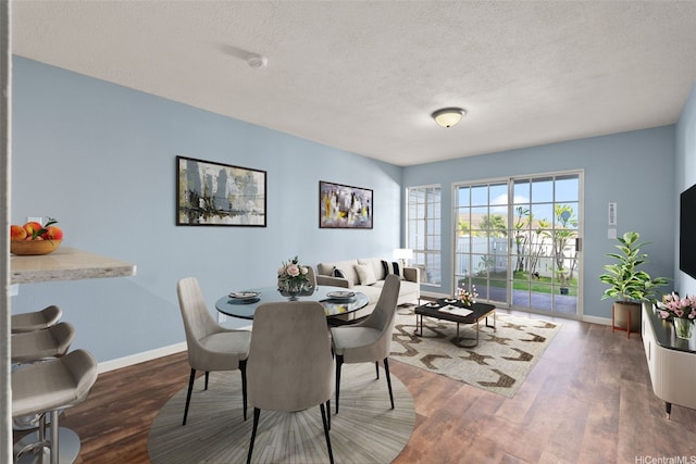 92-905 Hame Pl Unit 19-101, Kapolei, HI 96707 - dining room with baseboards, wood finished floors, and a textured ceiling