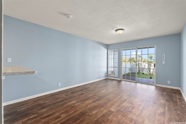 92-905 Hame Pl Unit 19-101, Kapolei, HI 96707 - spare room with dark wood-style flooring, a textured ceiling, and baseboards