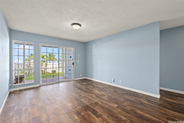 92-905 Hame Pl Unit 19-101, Kapolei, HI 96707 - unfurnished room featuring dark wood-style floors, baseboards, and a textured ceiling