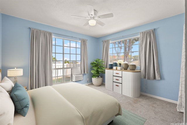 92-905 Hame Pl Unit 19-101, Kapolei, HI 96707 - carpeted bedroom featuring baseboards, a ceiling fan, and an AC wall unit
