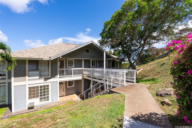 92-905 Hame Pl Unit 19-101, Kapolei, HI 96707 - view of front of house with stairway, a front yard, and a shingled roof
