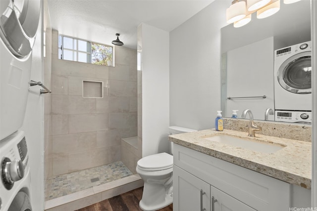 92-905 Hame Pl Unit 19-101, Kapolei, HI 96707 - full bath with estacked washer and dryer, wood finished floors, vanity, and toilet