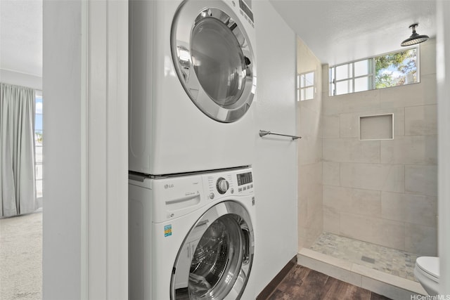 92-905 Hame Pl Unit 19-101, Kapolei, HI 96707 - laundry room with stacked washer / drying machine and dark wood-type flooring