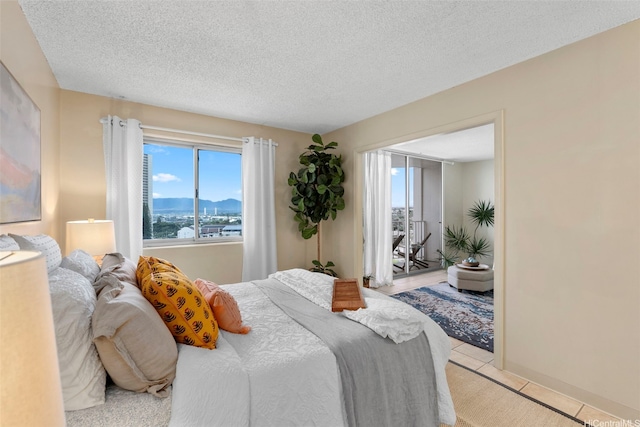 98-1038 Moanalua Rd Unit 1502, Aiea, HI 96701 - bedroom with light tile patterned floors, a textured ceiling, and access to exterior