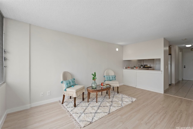 2542 Date St Unit 904, Honolulu, HI 96826 - living area with baseboards, a textured ceiling, and wood finished floors