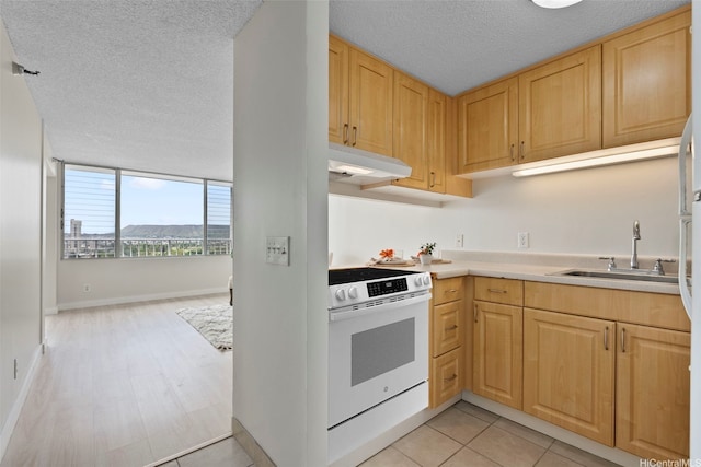2542 Date St Unit 904, Honolulu, HI 96826 - kitchen with white range, a textured ceiling, light brown cabinetry, a sink, and under cabinet range hood