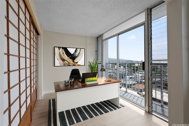 2542 Date St Unit 904, Honolulu, HI 96826 - office area featuring a wall of windows, a textured ceiling, and wood finished floors