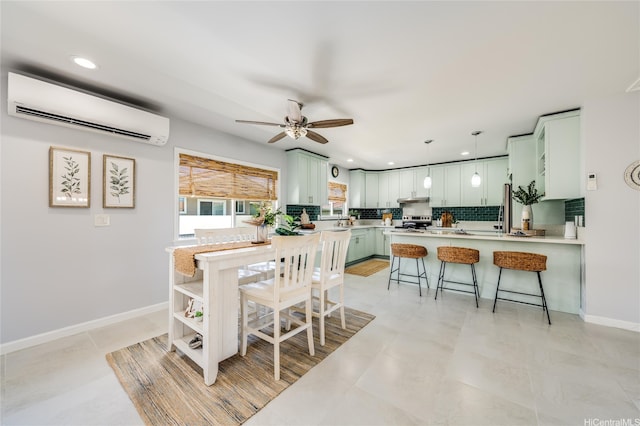 91-865 Ma Ke Kula St, Ewa Beach, HI 96706 - kitchen with an AC wall unit, a peninsula, a breakfast bar, stainless steel range with electric cooktop, and decorative backsplash