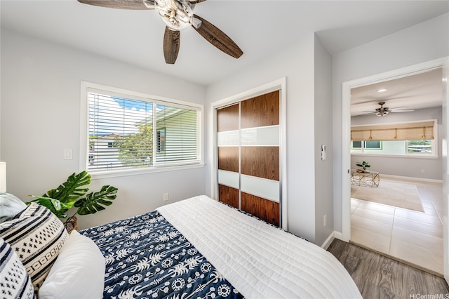91-865 Ma Ke Kula St, Ewa Beach, HI 96706 - bedroom featuring multiple windows, ceiling fan, a closet, and wood finished floors