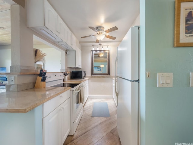 87-561 Farrington Hwy Unit 315, Waianae, HI 96792 - kitchen with light countertops, ceiling fan, white cabinetry, and white appliances