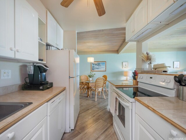 87-561 Farrington Hwy Unit 315, Waianae, HI 96792 - kitchen featuring light wood finished floors, open shelves, a ceiling fan, white appliances, and white cabinets