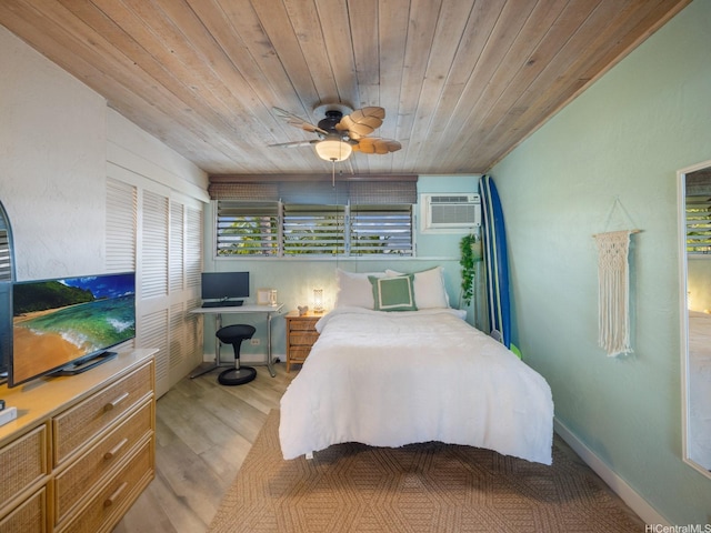 87-561 Farrington Hwy Unit 315, Waianae, HI 96792 - bedroom featuring an AC wall unit, ceiling fan, light wood-style flooring, and wood ceiling