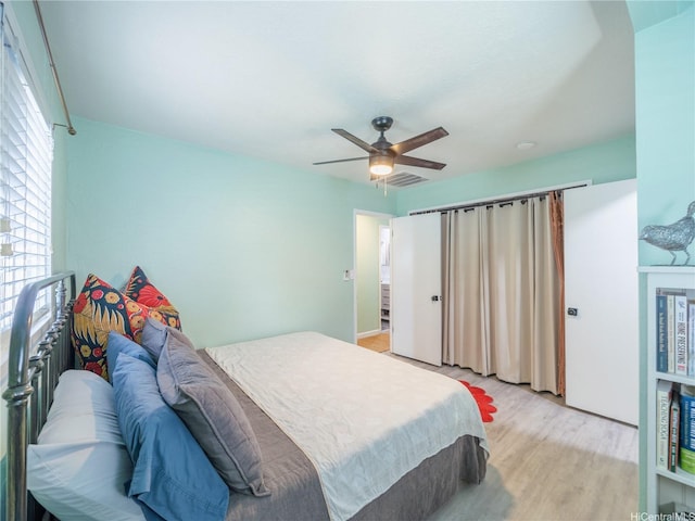 bedroom with a ceiling fan and light wood-style floors